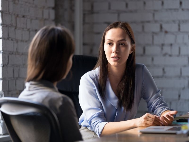 Grant writing image - Two women talking at desk