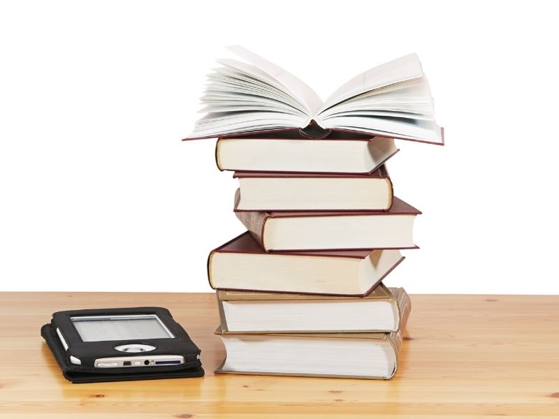 tablet next to stack of books